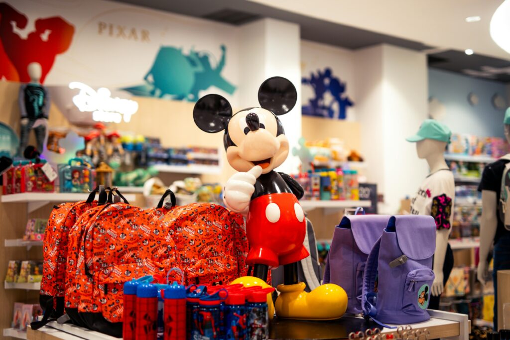 A vibrant retail display featuring Disney-themed merchandise, including play toys, with a prominent Mickey Mouse figure.